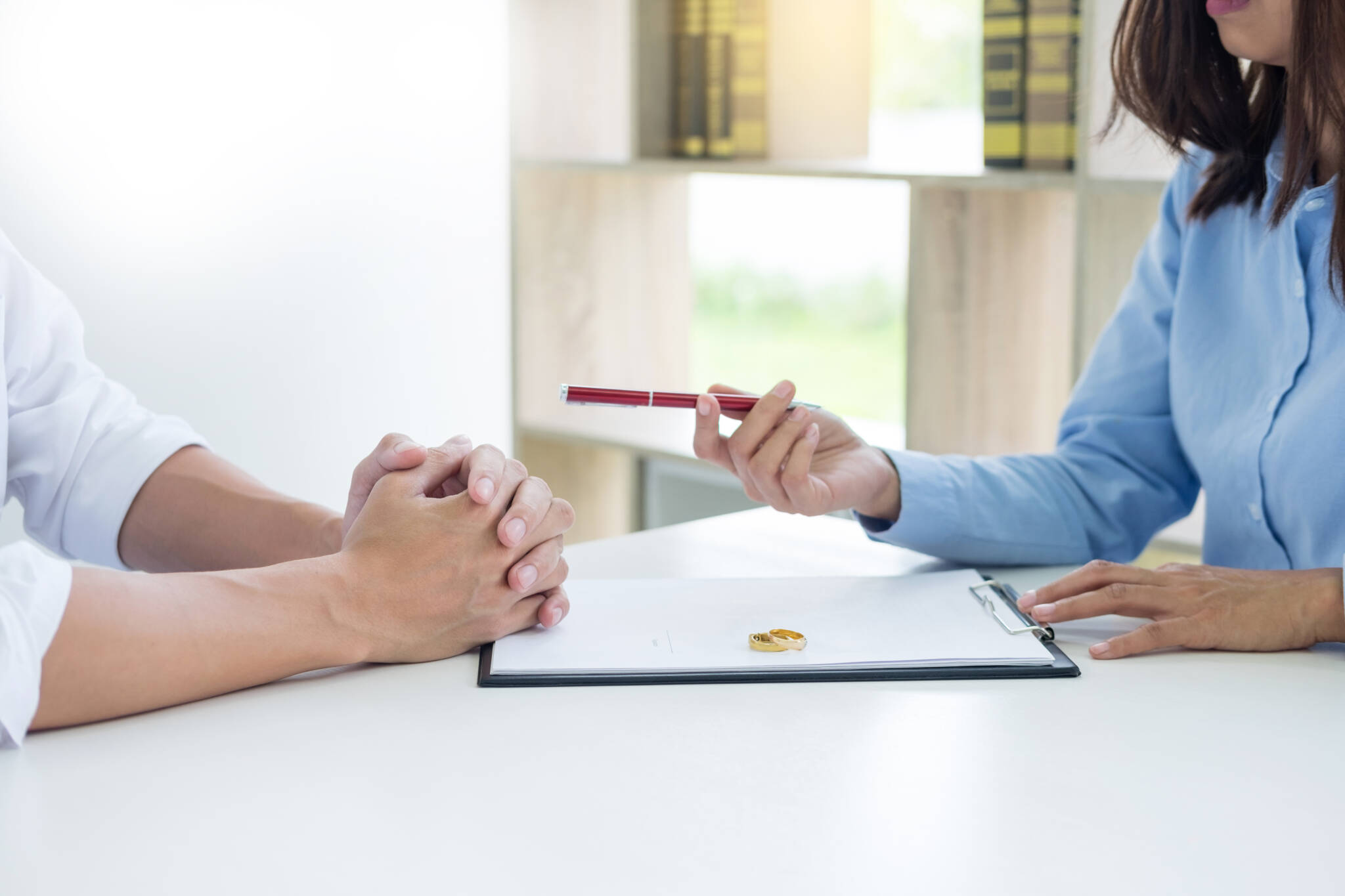 Closeup Of A Man Signing Contract Or Premarital Agreement, Filling Petition Form Agreement Of Divorce In Office At Lawyer Desk In Court Room Conceptual Of Marriage